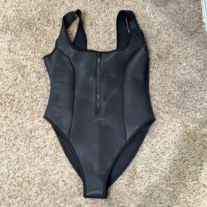 Skims rubberized  black one piece. Size Large. New with tags